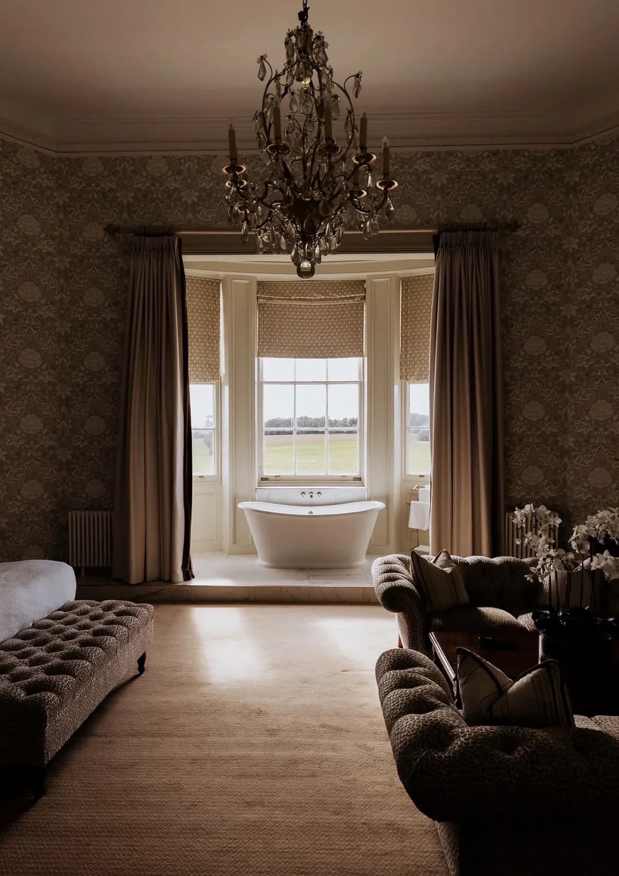 Freestanding bath and chandelier inside the Wynyard Hall accommodation suite
